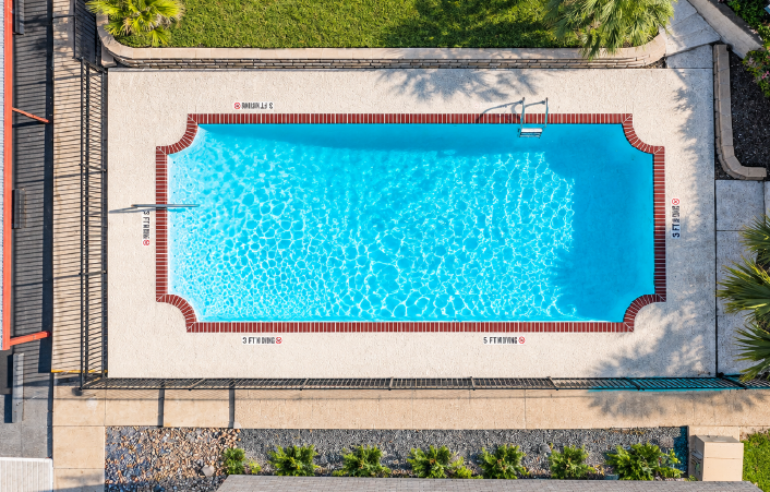 Poolside lounge chairs at Fairways 5 apartments